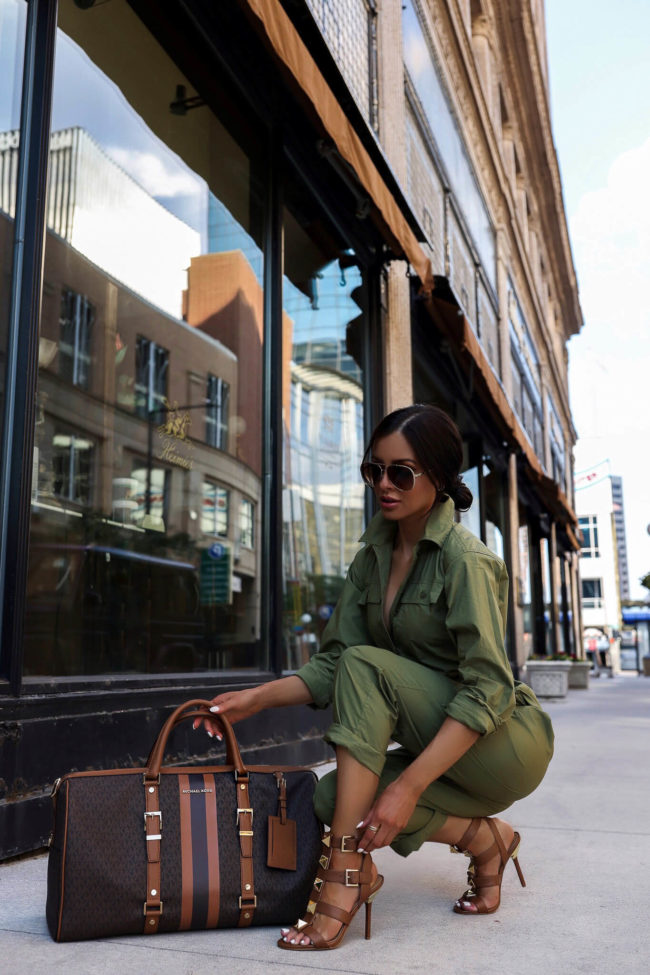 fashion blogger mia mia mine wearing a utility jumpsuit by michael kors