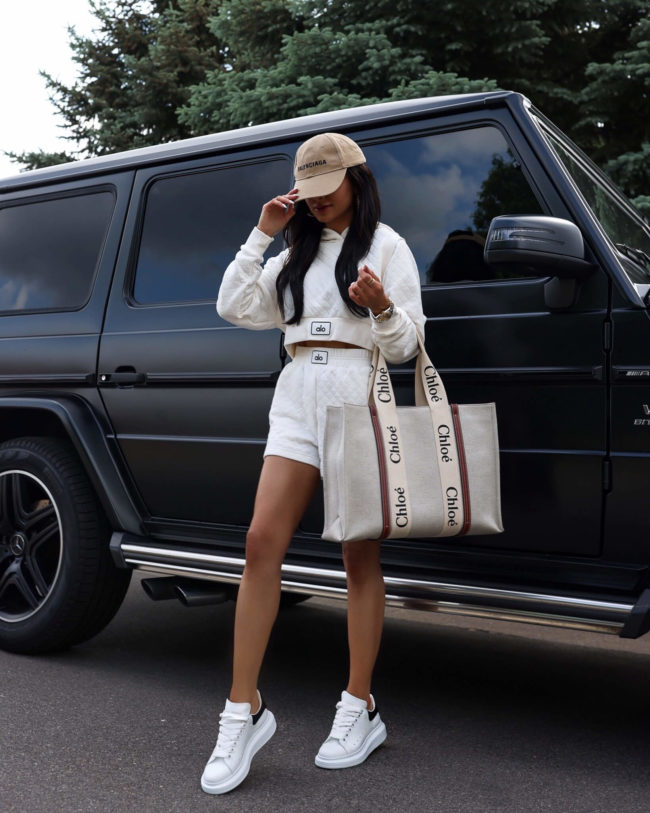 fashion blogger mia mia mine wearing an alo yoga quilted set and alexander mcqueen white sneakers