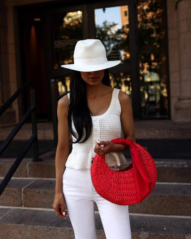 fashion blogger mia mia mine wearing an all white outfit with pops of red for summer