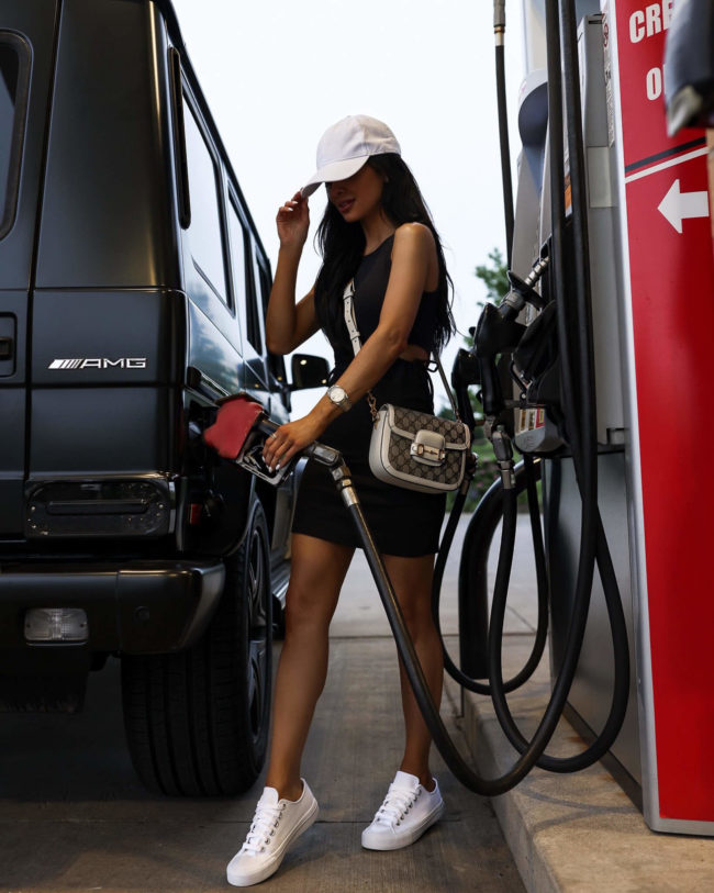 fashion blogger mia mia mine wearing a dress from walmart pumping fuel with a walmart + discount