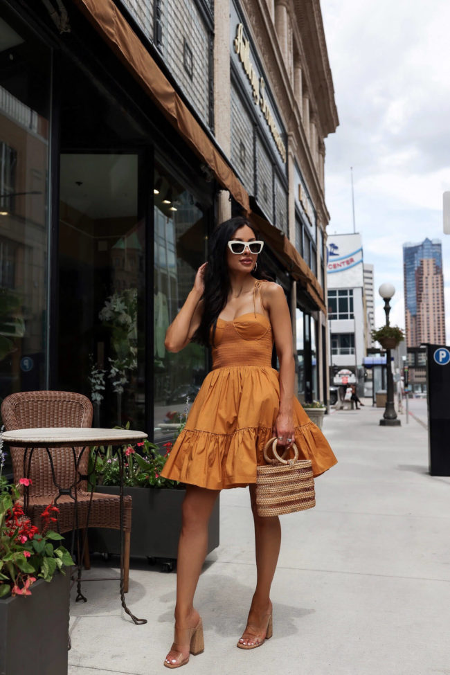 fashion blogger mia mia mine wearing a yellow dress for summer from saks fifth avenue