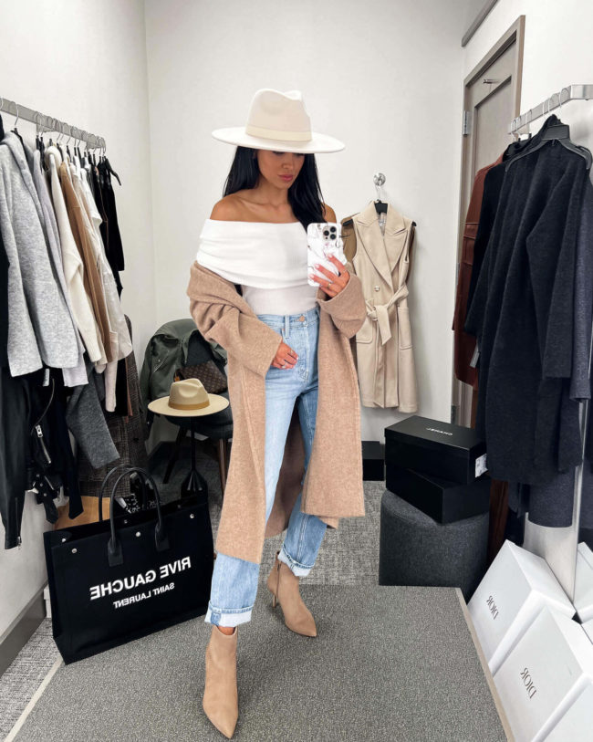 fashion blogger mia mia mine wearing a white off shoulder top by free people from the nsale 2022