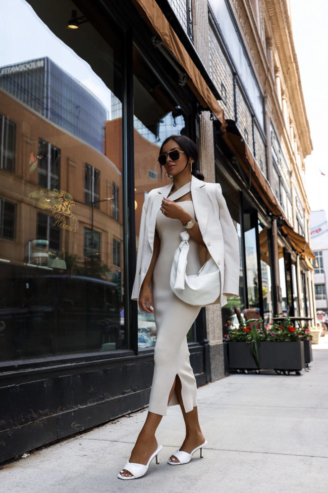 fashion blogger mia mia mine wearing an ivory midi dress from express
