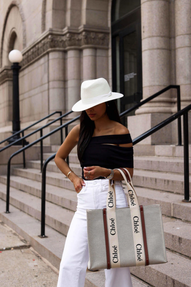 fashion blogger mia mia mine wearing a black and white summer outfit from saks