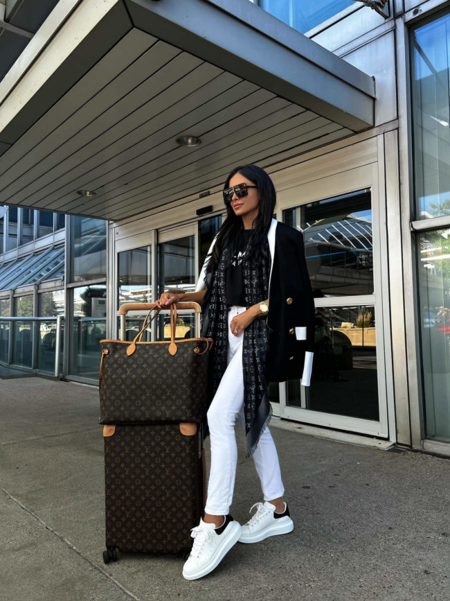fashion blogger mia mia mine with louis vuitton luggage at the airport