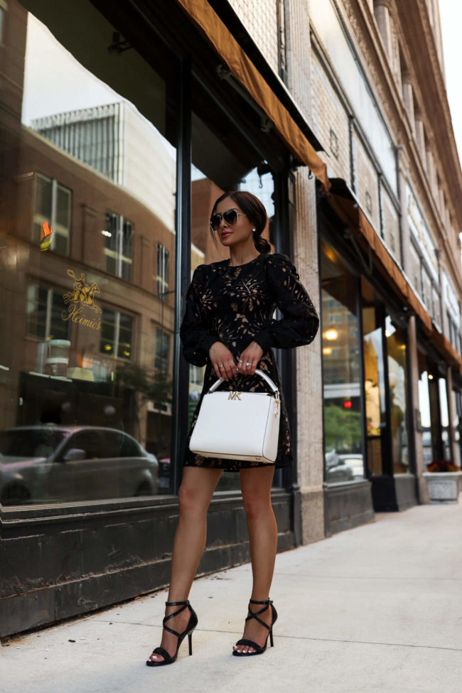 brunette fashion blogger wearing a black lace dress for fall