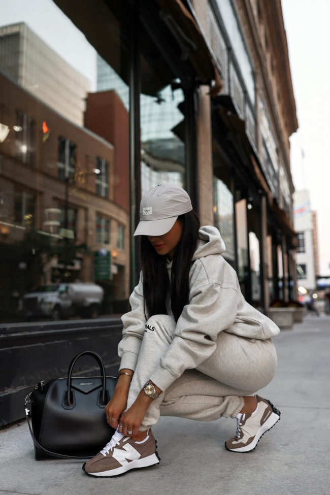 fashion blogger mia mia mine wearing new balance sneakers and an essentials sweatsuit from ssense