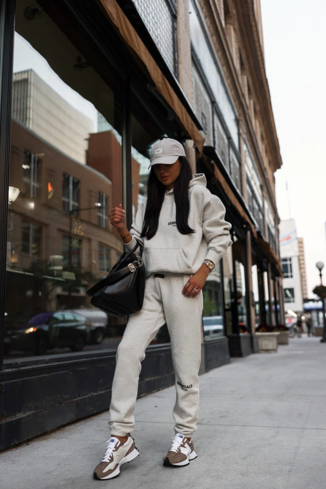 fashion blogger mia mia mine wearing an essentials sweatsuit from ssense for fall 2022