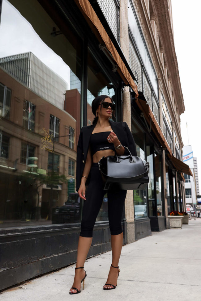 fashion blogger mia mia mine wearing a black tom ford activewear set from ssense