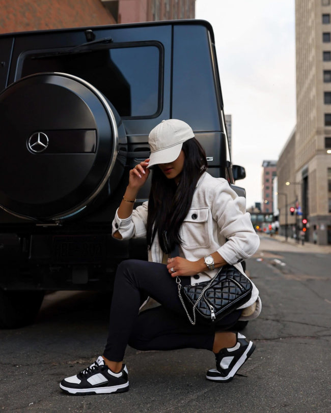 fashion blogger mia mia mine wearing black and white sneakers from walmart