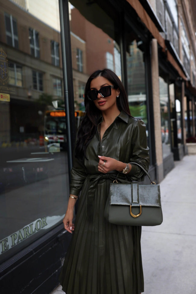 fashion blogger mia mia mine wearing an olive green faux leather dress for fall