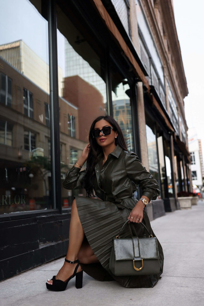 brunette fashion blogger wearing a faux leather green dress from walmart