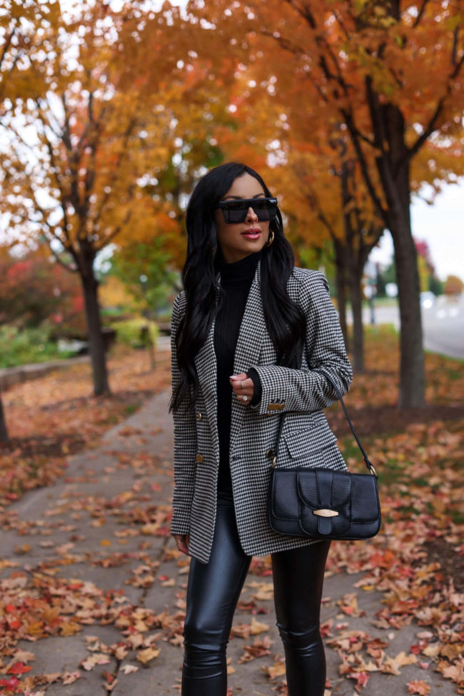 fashion blogger mia mia mine wearing a black houndstooth blazer