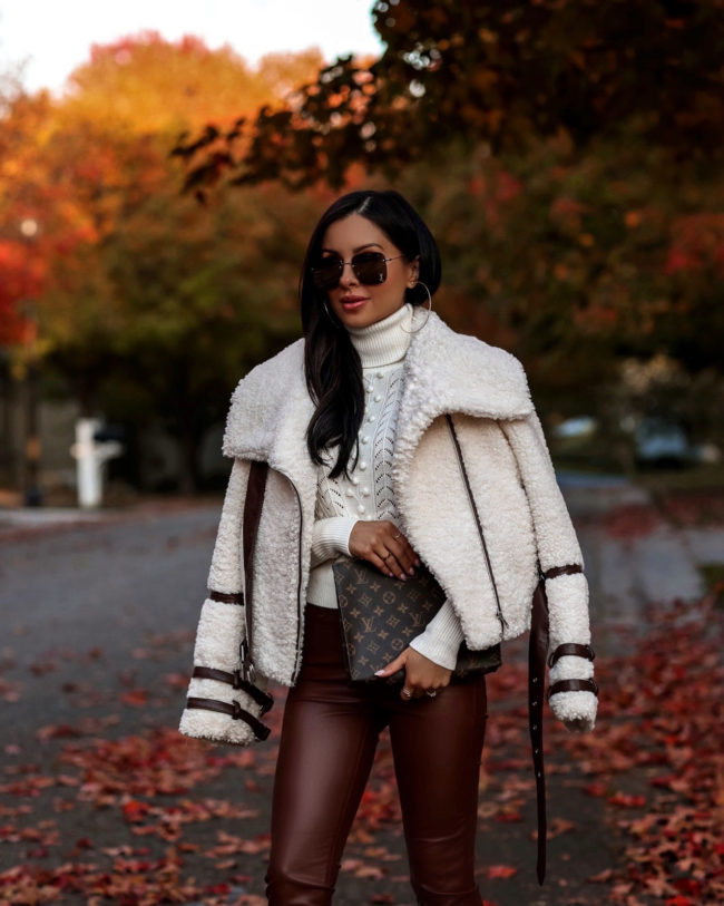 fashion blogger wearing a shearling jacket and leather pants for fall