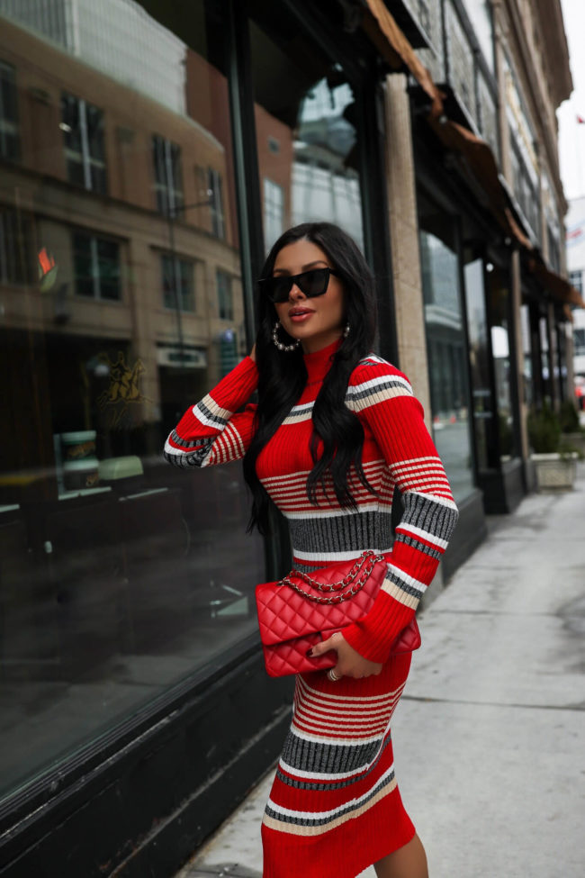fashion blogger wearing a striped red and white dress from walmart for the holidays