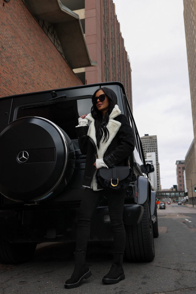 fashion blogger wearing a sherpa moto jacket and lug sole boots from walmart