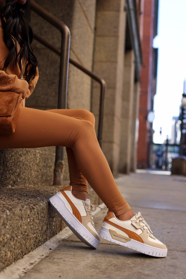 fashion blogger wearing camel cali sneakers by puma