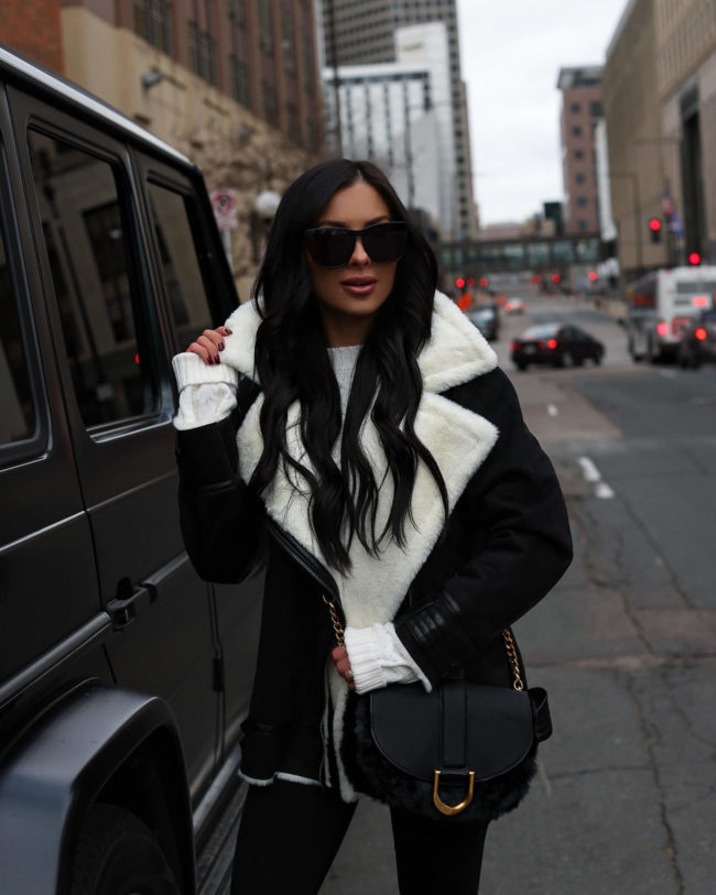 fashion blogger mia mia mine wearing a sherpa jacket from walmart