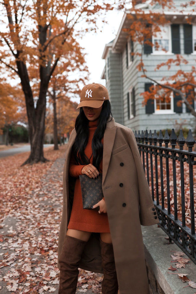 fashion blogger wearing a rust colored sweater dress