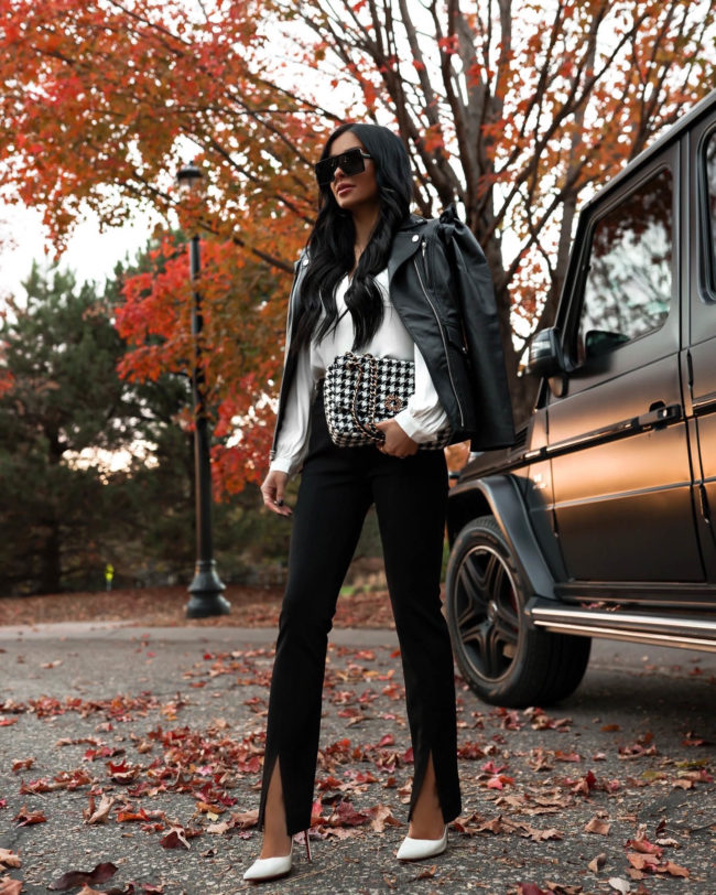 fashion blogger wearing a leather jacket and split hem pants from whbm