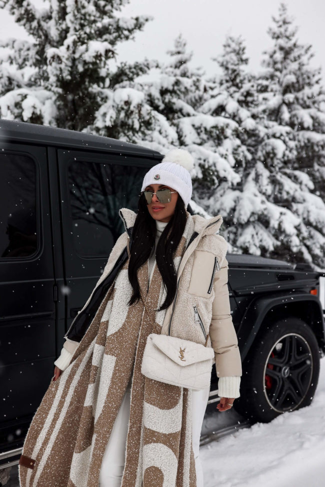 fashion blogger mia mia mine wearing a white moncler beanie for winter