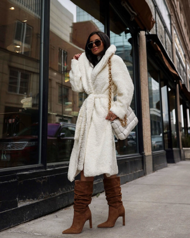 brunette fashion blogger wearing a white cozy coat for winter