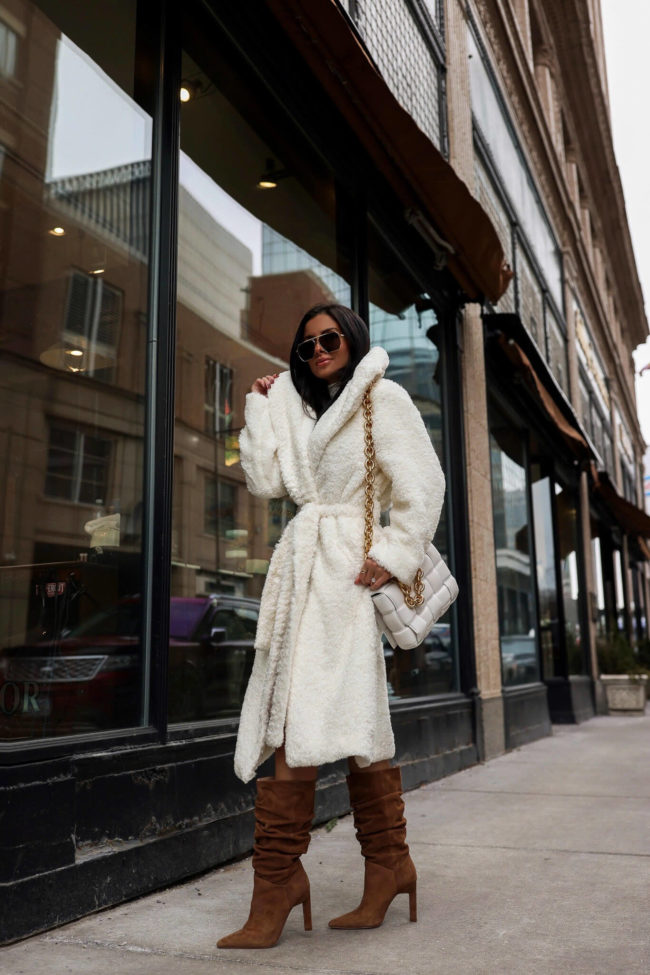 brunette fashion blogger wearing a white cozy coat for winter