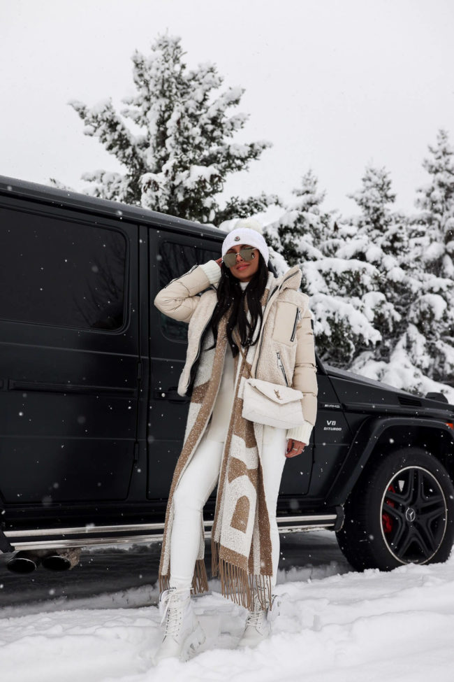 fashion blogger mia mia mine wearing a white winter outfit from saks fifth avenue