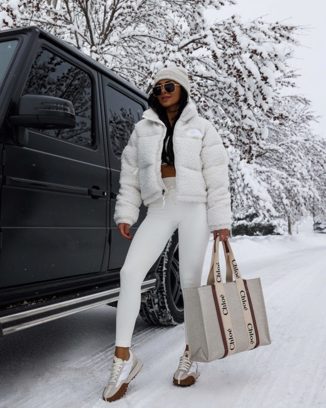 fashion blogger mia mia mine wearing a white sherpa jacket by the north face