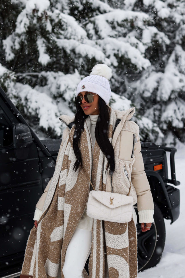 fashion blogger mia mia mine wearing a white puffer jacket and burberry scarf from saks
