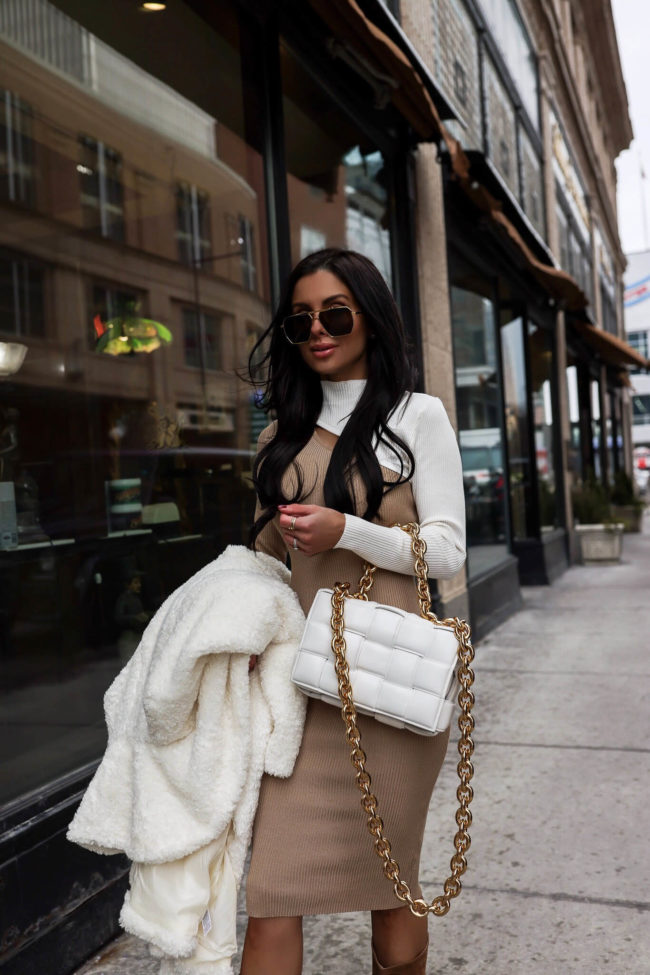 fashion blogger mia mia mine wearing a white and camel sweater dress from walmart