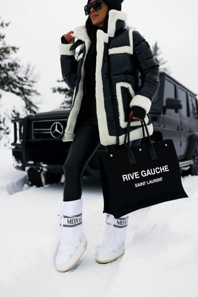 fashion blogger wearing white moon boots in the snow
