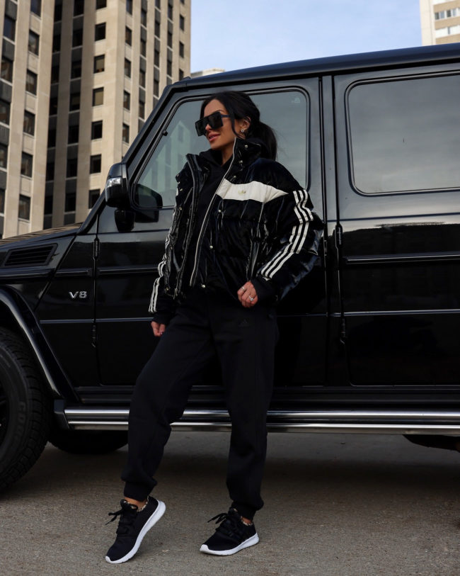 fashion blogger mia mia mine wearing an adidas puffer jacket and sweatpants