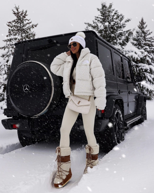 mia mia mine wearing shearling moon boots in the snow