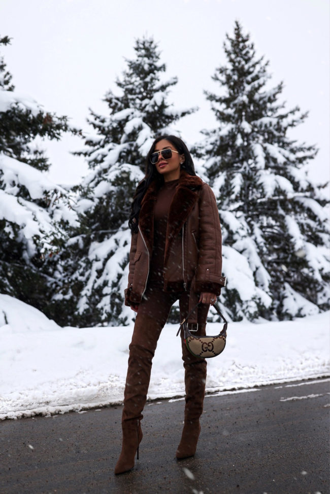 fashion blogger wearing a brown jumpsuit and brown over the knee boots from nordstrom