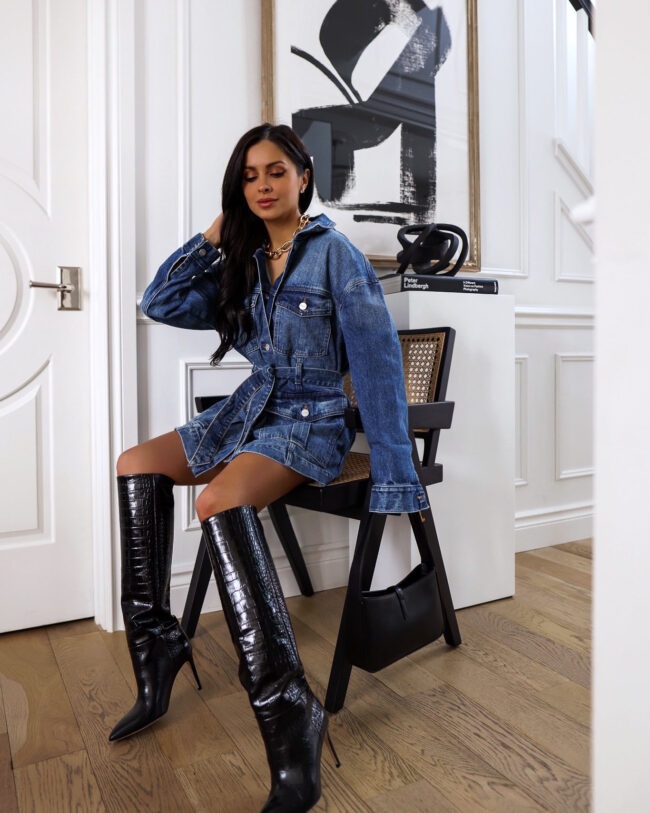 fashion blogger wearing a denim jacket and knee high boots