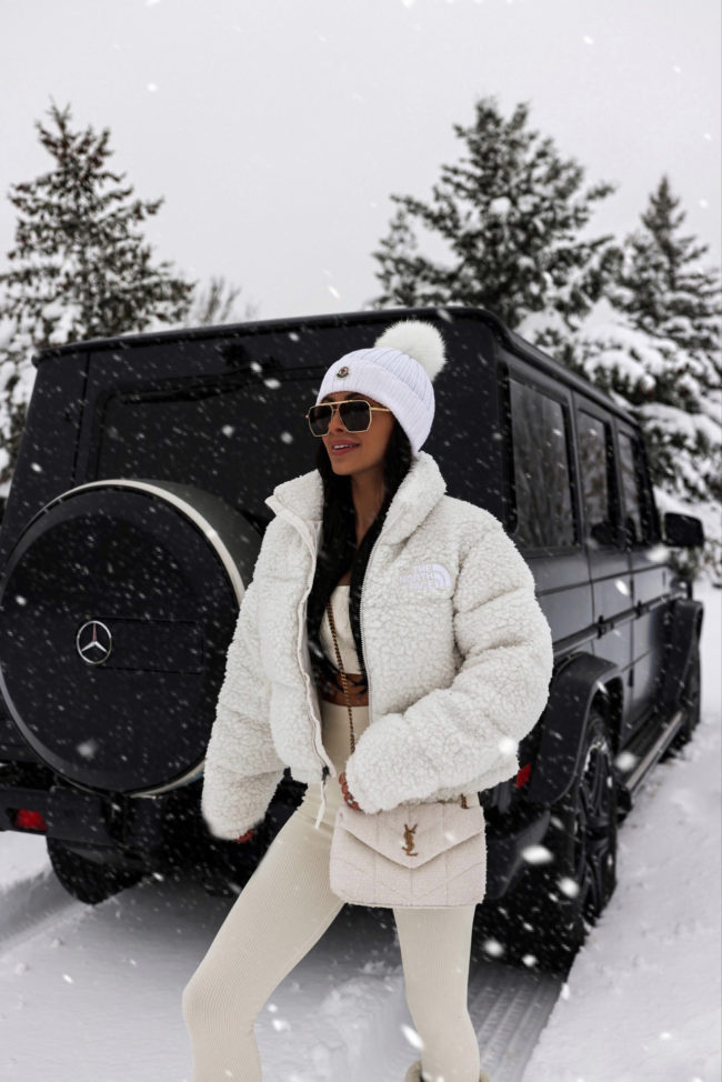 fashion blogger wearing a white shearling puffer jacket by north face