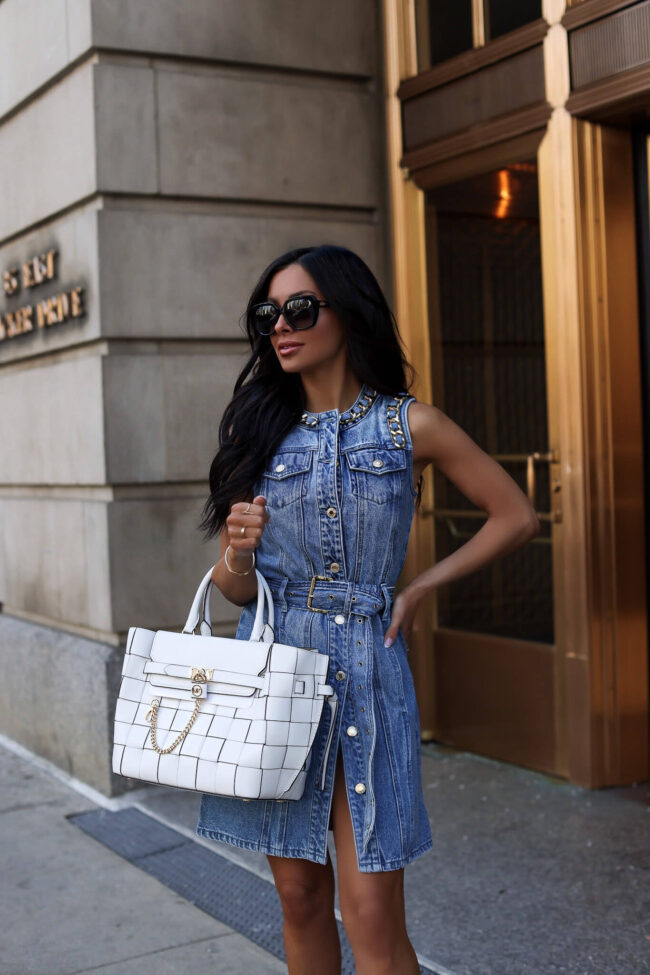mia mia mine wearing a denim dress with gold chain details by michael kors