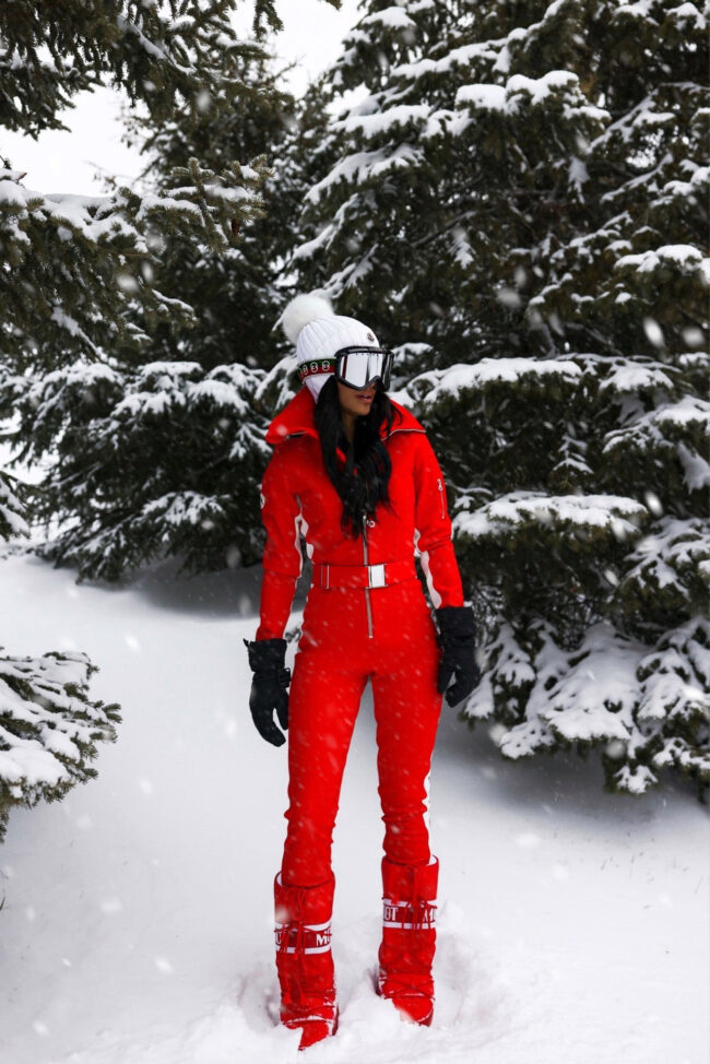 fashion blogger mia mia mine wearing a red ski suit by cordova