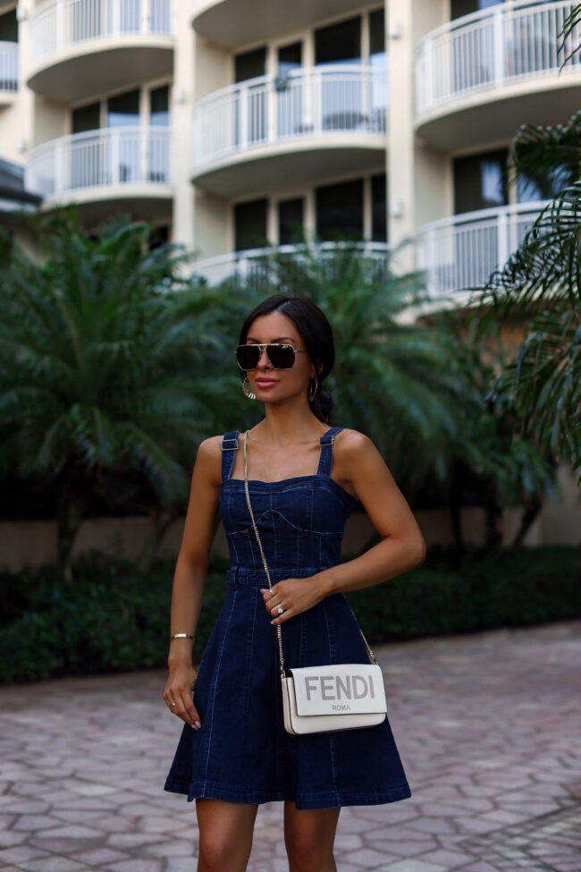 fashion blogger wearing a denim mini dress
