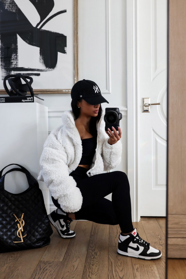 fashion blogger wearing a black and white athleisure outfit