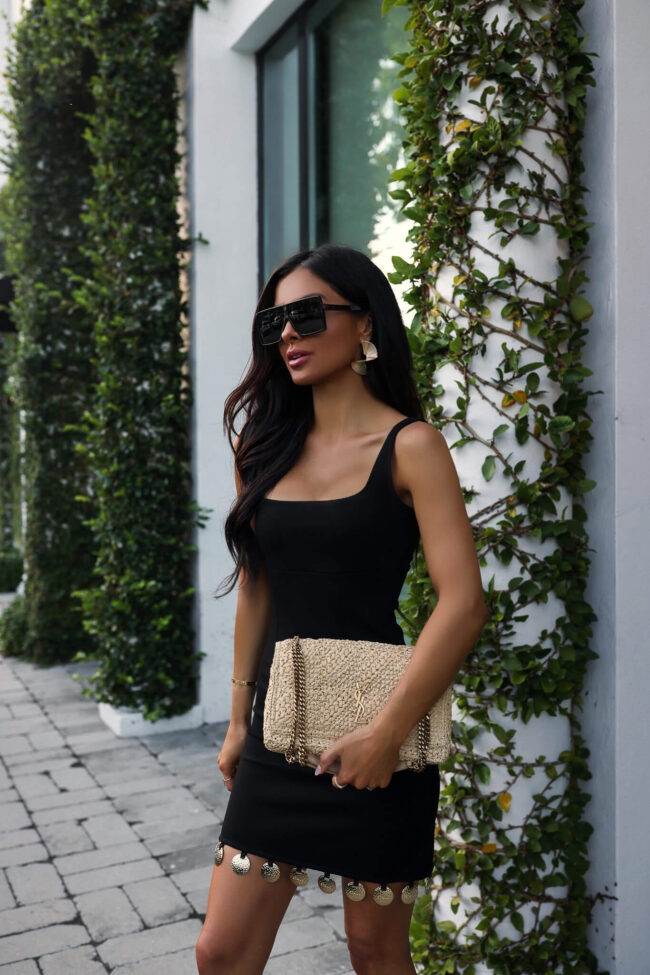 fashion blogger mia mia mine wearing a black staud mini dress in palm beach florida
