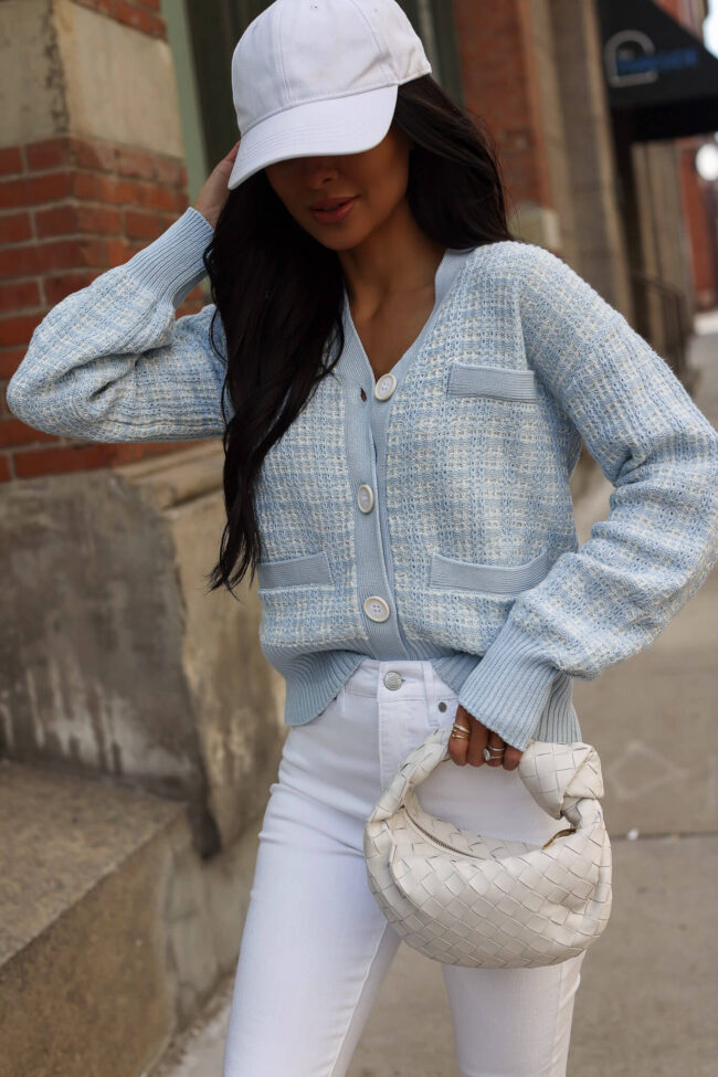 fashion blogger wearing a blue and white cardigan from walmart