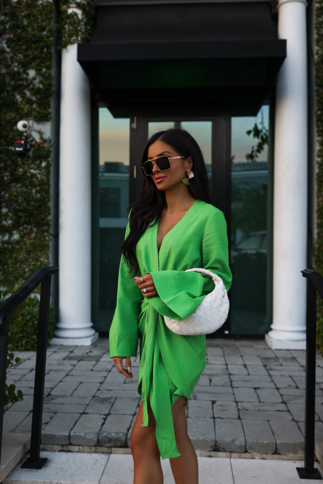 mia mia mine wearing a green dress from revolve