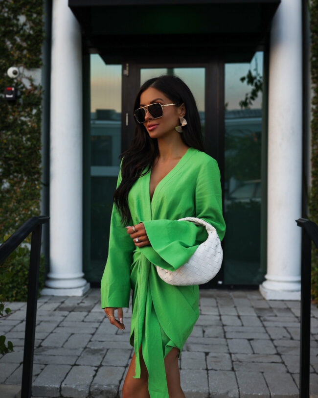 fashion blogger wearing a bright green dress