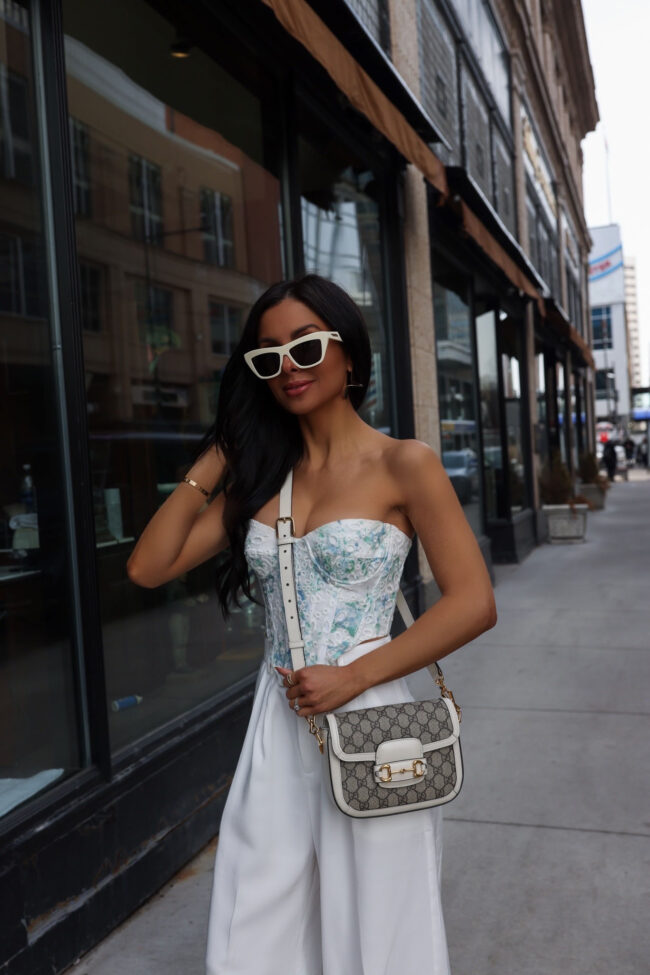 fashion blogger mia mia mine wearing a floral corset from revolve