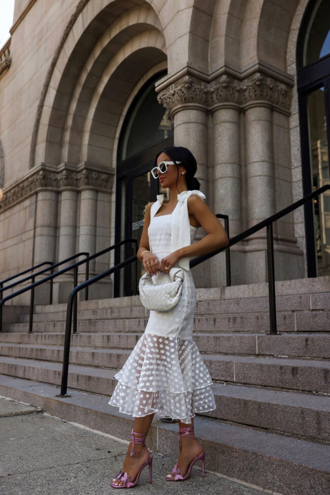 fashion blogger mia mia mine wearing a white ruffle dress and pink butterfly sandals