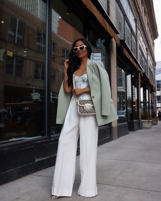 fashion blogger wearing white wide leg pants and a corset