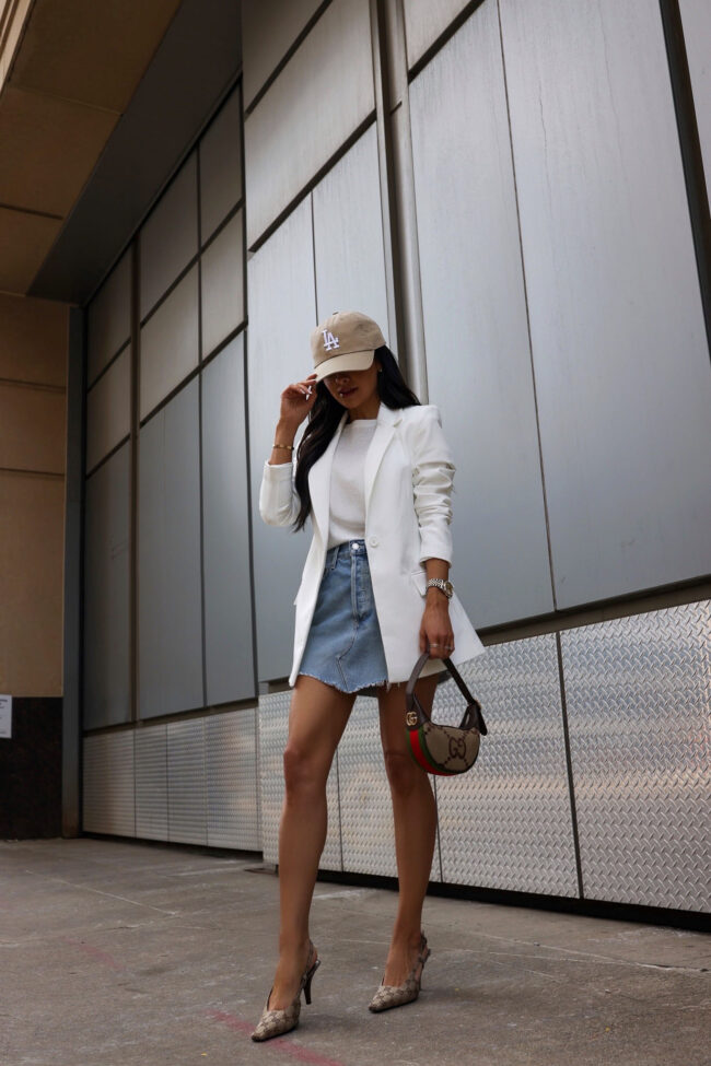 fashion blogger wearing a denim skirt and white blazer