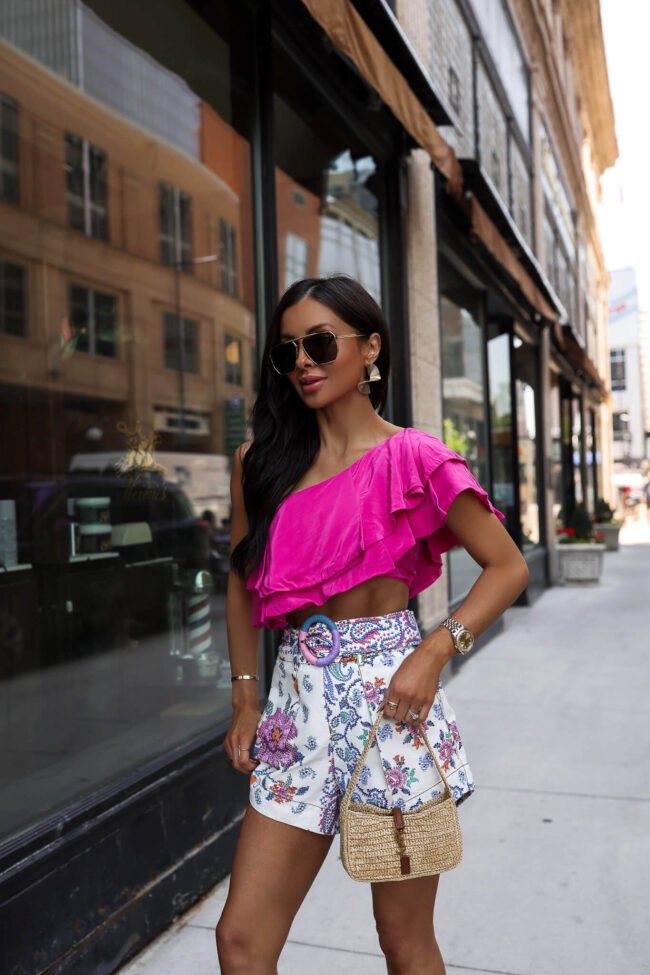 fashion blogger mia mia mine wearing a pink off the shoulder top from saks